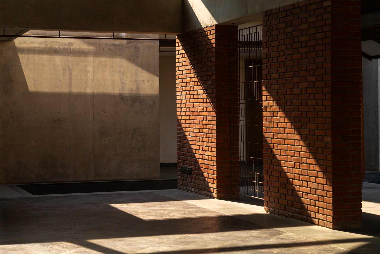 Sunlit brick interior corridor at Eshanya Estates